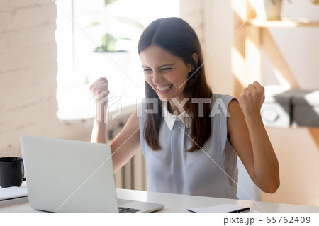 Overjoyed young woman feel excited read good news on laptop Overjoyed young woman feel excited read good news on laptop 65762409