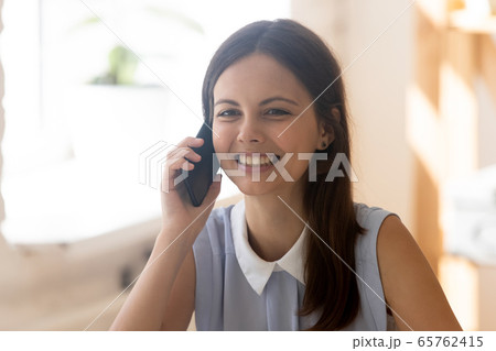Smiling young girl have pleasant cellphone call Smiling young girl have pleasant cellphone call 65762415
