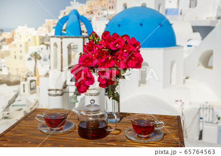 Morning tea  against the architecture of Santorini 65764563