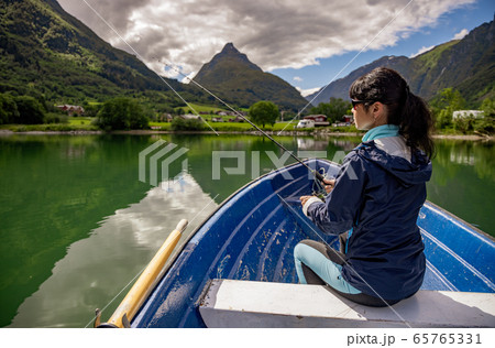 Woman fishing on a boat. Woman fishing on a boat. 65765331