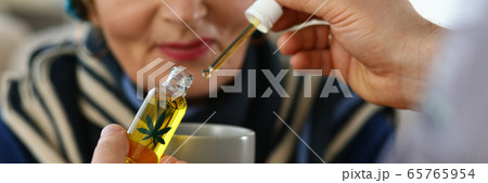 Elderly woman receives sedative drops from doctor. Elderly woman receives sedative drops from doctor. 65765954