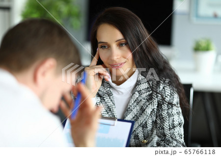 Woman listens attentively to upset office employee 65766118
