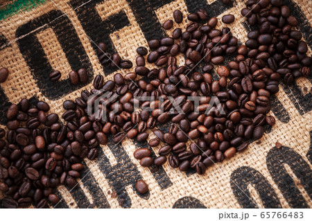 Roasted coffee beans are on jute bag fabric 65766483