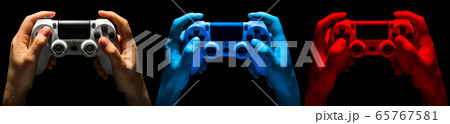 Set of hands holding video game gamepad in neon Set of hands holding video game gamepad in neon 65767581