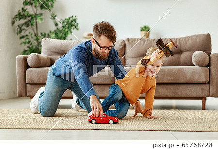 Young father and kid playing with toys at home. 65768728