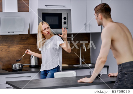 man dissatisfied with what his wife is cooking 65769059
