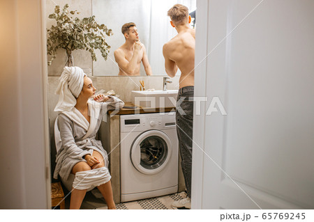 young caucasian couple spend morning together in toilet young caucasian couple spend morning together in toilet 65769245