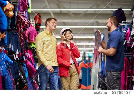 smiling caucasian couple listen to pleasant salesman 65769457