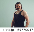 Male bodybuilder wearing dark tanktop on ripped 65770047