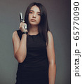 Shot of a sexy military woman posing with guns 65770090
