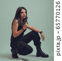 Shot of a sexy military woman posing with guns 65770126