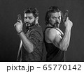 weapons in the hands of two gangster men,they look 65770142