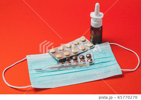 Spray with medical mask and medicines on colorful Spray with medical mask and medicines on colorful 65770270