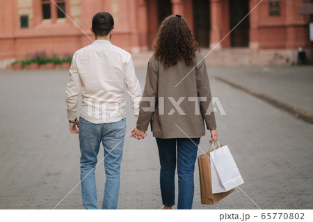 Man and woman with bags after shopping in the city. Happy woman 65770802