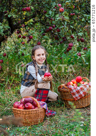 Portrait of a cute girl in a farm garden with a 65771216
