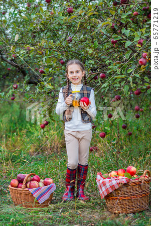 Portrait of a cute girl in a farm garden with a 65771219