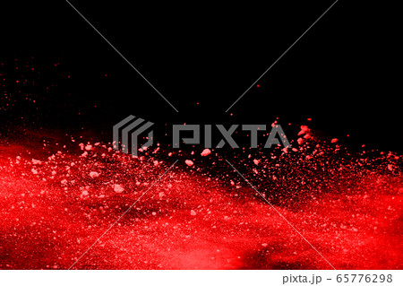 abstract red powder explosion on black background.abstract red powder splatted on black background. Freeze motion of red powder exploding. 65776298