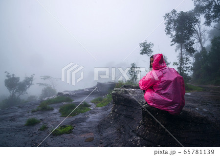 tourist with pink rain coat Sitting View the scenery natural beautiful touch fog tourist with pink rain coat Sitting View the scenery natural beautiful touch fog 65781139