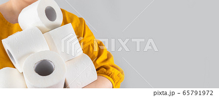Female hands holds many rolls of toilet paper on Female hands holds many rolls of toilet paper on 65791972
