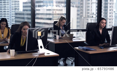 Business people working with desktop computer in office.  65793486