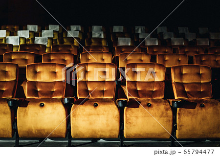 A row of yellow seat in the movie theater A row of yellow seat in the movie theater 65794477