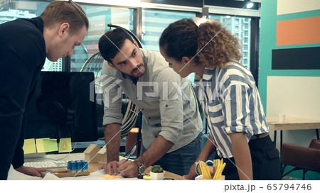 Creative business people group having conversation at office desk. 65794746