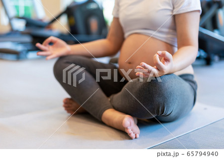 Active pregnant woman exercise in fitness center. Active pregnant woman exercise in fitness center. 65794940