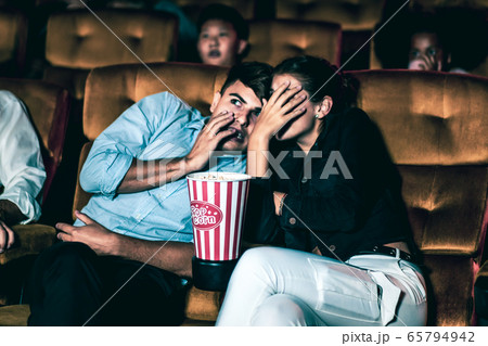 A couple lover watching movie in cinema theater. 65794942