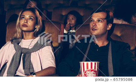 People audience watching movie in cinema theater. People audience watching movie in cinema theater. 65795086