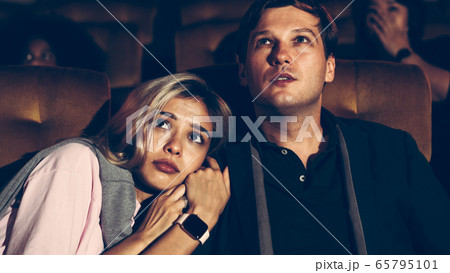 People audience watching movie in cinema theater. 65795101