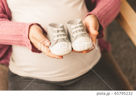 Happy pregnant woman and expecting baby at home. 65795232