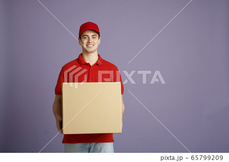 Fast delivery and big parcel. Caucasian post worker gives out big box 65799209