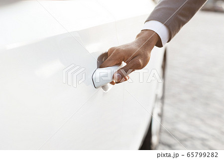 Unrecognizable Black Businessman Opening Automobile Door In City, Cropped Unrecognizable Black Businessman Opening Automobile Door In City, Cropped 65799282