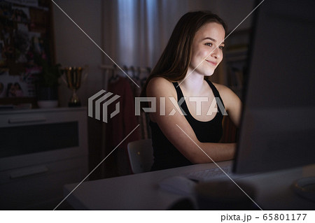 Beautiful happy young girl with laptop sitting and smiling, online dating concept. Beautiful happy young girl with laptop sitting and smiling, online dating concept. 65801177