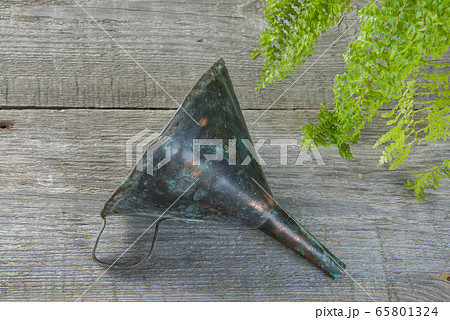 Antique brass funnel with handle on wooden 65801324