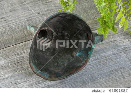 Antique brass funnel with handle on wooden 65801327