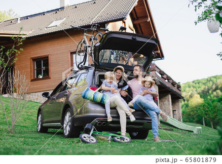 Family with two small children and dog going on cycling trip in countryside. 65801879
