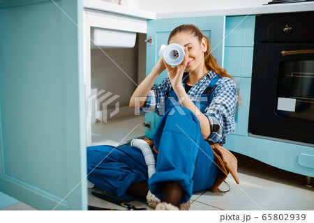 Female plumber lying on the floor, top view Female plumber lying on the floor, top view 65802939