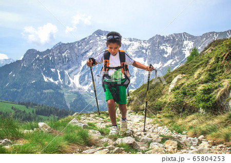 Little boy walks  during an excursion on mountain 65804253