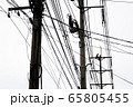 A technician climbing on electricity post to fix a 65805455