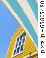 A green blue striped awning with yellow house and 65805480