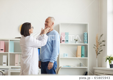 Female Doctor Examining Senior Man during Consultation Female Doctor Examining Senior Man during Consultation 65805943