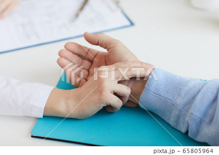 Doctor Timing Pulse of Senior Patient 65805964