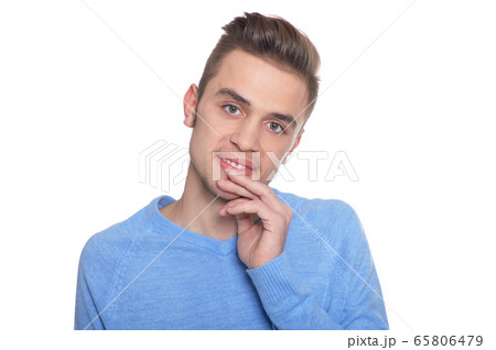 Handsome young man posing against white background 65806479