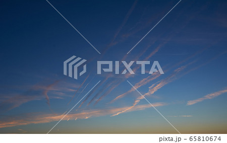 Intense blue sky with small white clouds 65810674