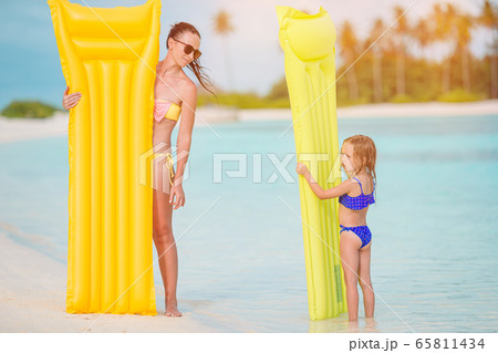 Beautiful mother and daughter at Caribbean beach enjoying summer vacation. 65811434