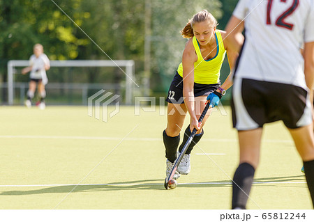 Field hockey female player lead the ball in attack 65812244