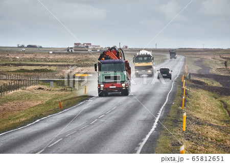 Truck driving on wet road in Iceland Truck driving on wet road in Iceland 65812651