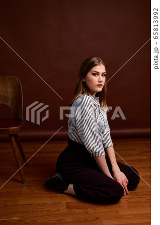 Gorgeous young female in classic suit, black shoes 65813992