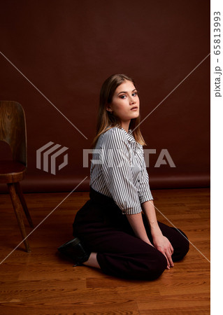 Gorgeous young female in classic suit, black shoes 65813993
